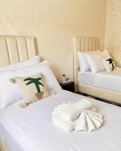 a bedroom with two beds with white sheets at Marrakech home in Marrakesh