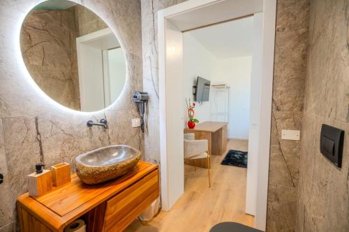a bathroom with a sink and a mirror at Tenuta Bruni - Agriturismo & Pool in Squinzano