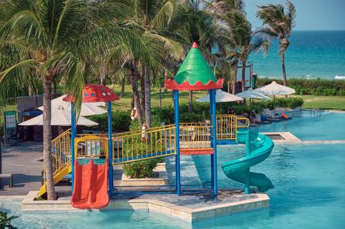 a playground in a resort with a slide in the water at Sunrise Pool Villa Cam Ranh in Cam Ranh