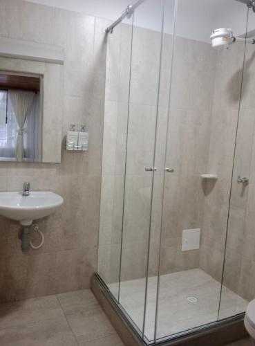a bathroom with a shower and a sink at Hotel La Palmita in Pacho