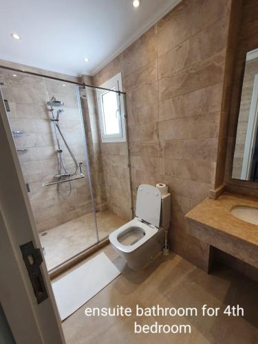 a bathroom with a shower and a toilet and a sink at Almaza bay Beach Town Chalet in Marsa Matruh
