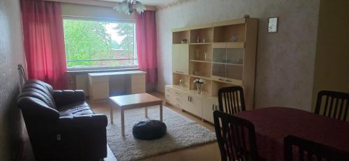 a living room with a couch and a table and a window at Pankkikallio 8 in Sorsakoski
