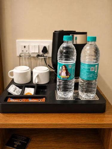 two bottles of water are sitting on a tray at Hotel Stayzzy Bloom in Noida