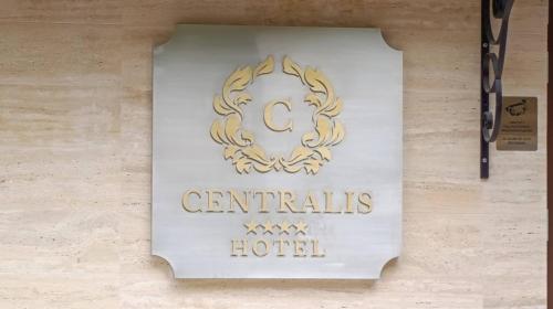 a sign for a centrists hotel on a wall at Centralis Hotel in Haskovo