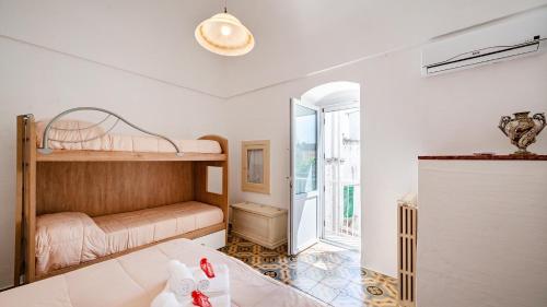 a living room with a bunk bed and a doorway at Casa Cenzina by Rentbeat in Locorotondo
