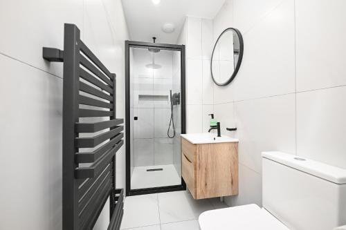 a bathroom with a shower and a toilet and a sink at Soundview in Lerwick