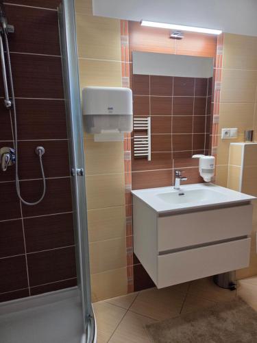 a bathroom with a sink and a shower at Apartmán KATY in Rajecké Teplice