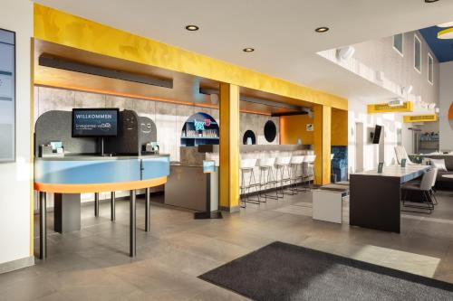 a restaurant with a blue counter and yellow walls at Hey Lou Hotel Nördlingen in Nördlingen
