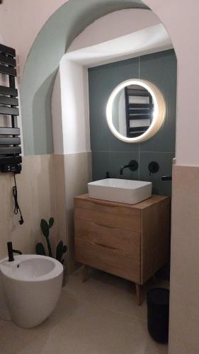 a bathroom with a tub and a sink and a mirror at Al vecchio Incasato in Grottammare