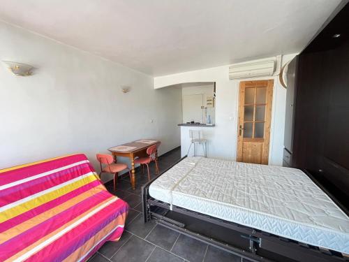 a bedroom with a bed and a desk and a table at Studio Bandol Port in Bandol