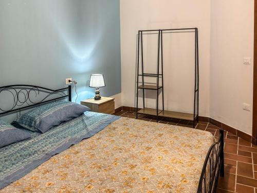 a bedroom with a bed and a chair at Villa GioCar in Castelsardo
