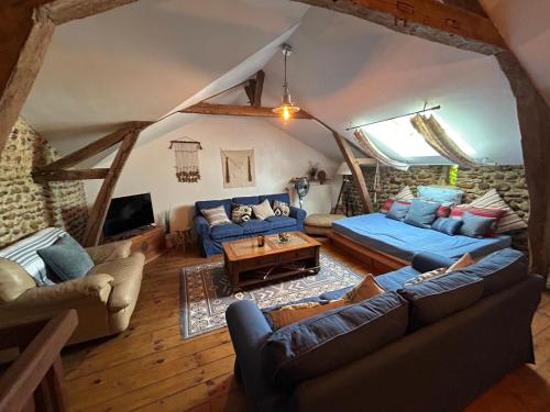 an overhead view of a living room with blue couches at Country Farmhouse with pool in Lascazères