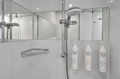 a shower with two shampoo bottles in a bathroom at Four Points Flex by Sheraton Newcastle in Newcastle upon Tyne