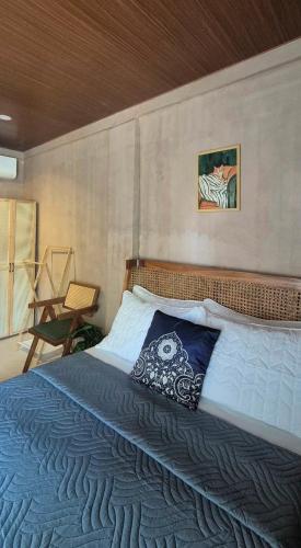 a bedroom with a large bed with a blue blanket at Casa Elia l Beach Nook Suite l Walk to Beach&Surf in San Juan