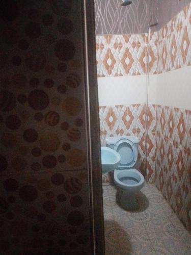 a bathroom with a toilet and a sink at Oundo LVHAR in Busia