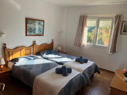 a bedroom with two beds with towels on them at EL MIRADOR in Alaior