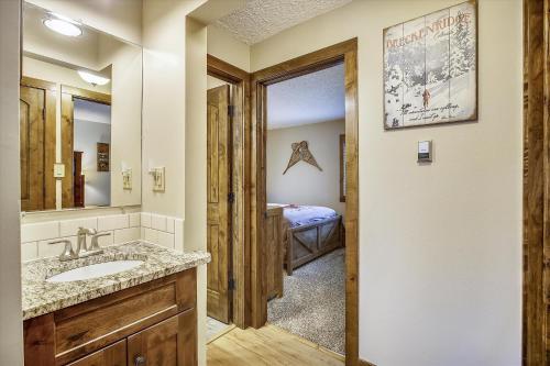 a bathroom with a sink and a bedroom at Tannhauser 222 in Breckenridge