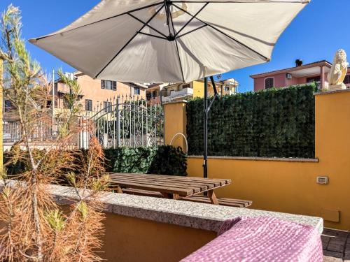 a patio with a table and an umbrella at Villa GioCar in Castelsardo