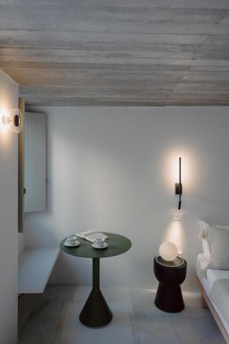 a living room with a table and a couch at Domino in Ermoupoli