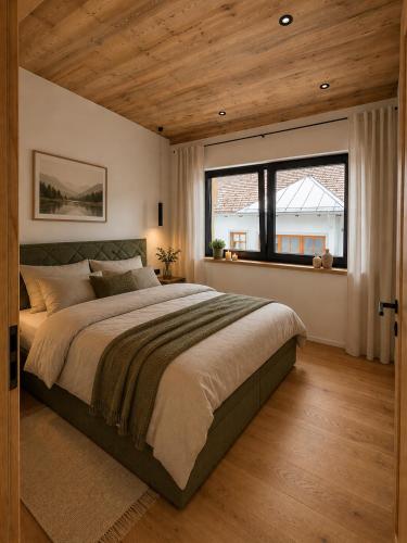 a bedroom with a large bed and a large window at Eben Central Living in Eben im Pongau