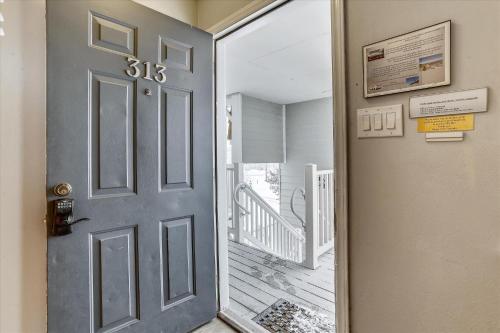 a door leading to a hallway with a staircase at Tannhauser 313 in Breckenridge