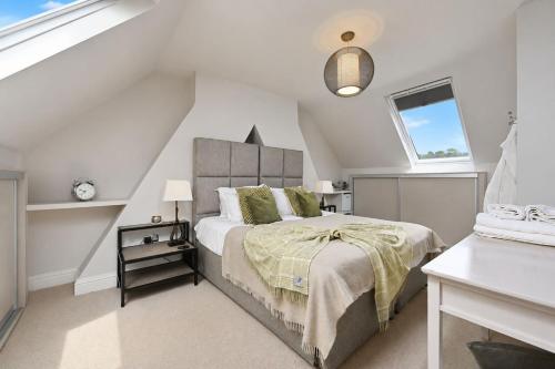 a bedroom with a bed and a window at Hydrangea House in Hythe