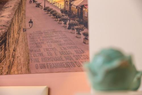 a picture of a street with plants on a wall at F53 Kevin's Charming Houses in Alghero