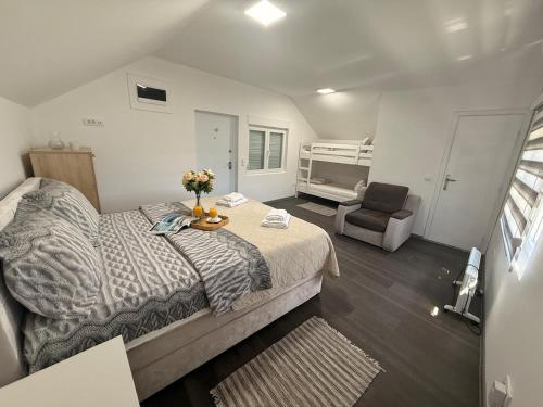 a bedroom with a bed and a chair in it at Kosmaj Thalia in Babe