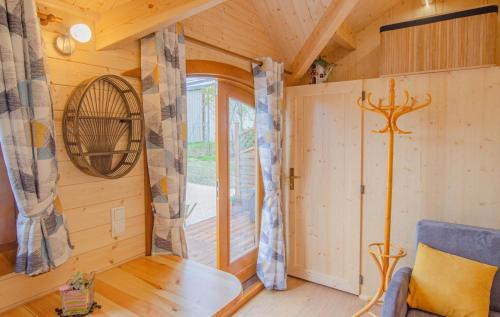 a tiny house with a room with a window at Le chalet pour la nuit in Pont-Sainte-Marie
