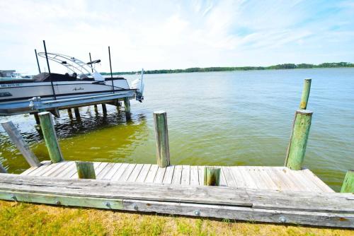 a boat is docked at a dock on the water at Ocean Pines-Harborview Drive 17 home in Ocean Pines