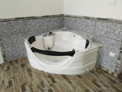 a white bath tub sitting in a room at Hotel el sol Caraz in Caraz