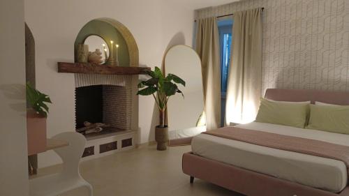 a bedroom with a bed and a fireplace at Al vecchio Incasato in Grottammare