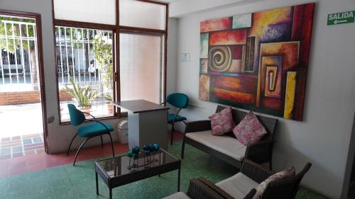 a living room with a couch and a painting on the wall at Hogar de Paso Santa Teresa in Cúcuta