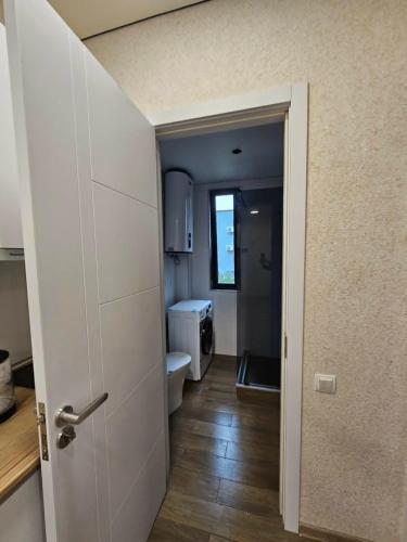 an open door to a bathroom with a toilet at Sun Estate Ureki in Ureki