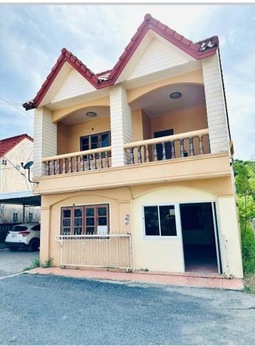 a house with a balcony on top of it at The Jetty in Nathon Bay