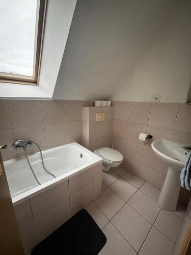 a bathroom with a tub and a toilet and a sink at Sea House in Puck Free Parking in Puck