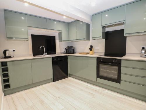 a kitchen with blue cabinets and a sink at 2 Bed in Southampton