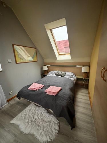 a bedroom with a bed with a window and a rug at Sea House in Puck Free Parking in Puck