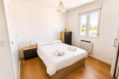 a bedroom with a bed with two pillows on it at Brisa de Usil in Mogro