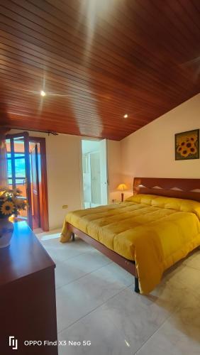 a bedroom with a large bed and a wooden ceiling at Villa Rosaria B&B in Morano Calabro
