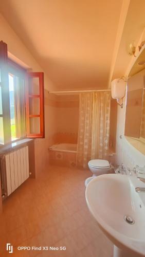 a bathroom with a sink and a toilet and a tub at Villa Rosaria B&B in Morano Calabro
