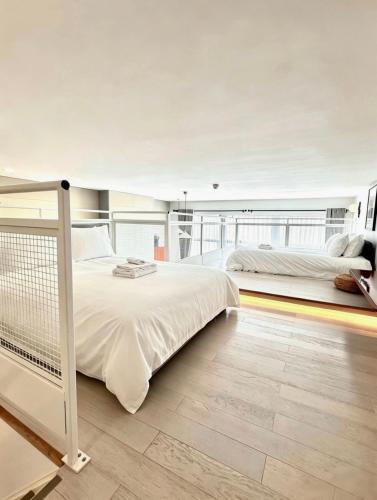 a bedroom with two beds and a balcony at Trueman Court Luxury Serviced Apartments in Liverpool