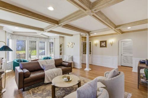 a living room with a couch and a table at Spacious Proctor Tudor-Sleeps 16-Dog Friendly-Walk in Tacoma