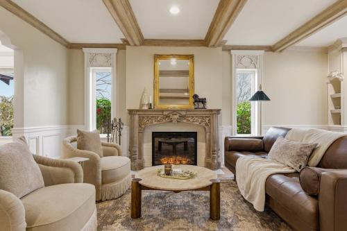a living room with a couch and a fireplace at Spacious Proctor Tudor-Sleeps 16-Dog Friendly-Walk in Tacoma