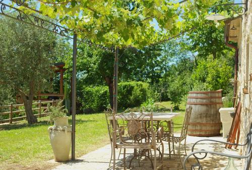 a patio with a table and chairs under a canopy at Dimora del Capriolo in San Donato Val di Comino