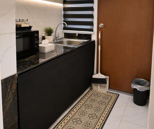 a kitchen with a sink and a counter top at Dmana Homestay Arau Perlis Tiny House in Arau