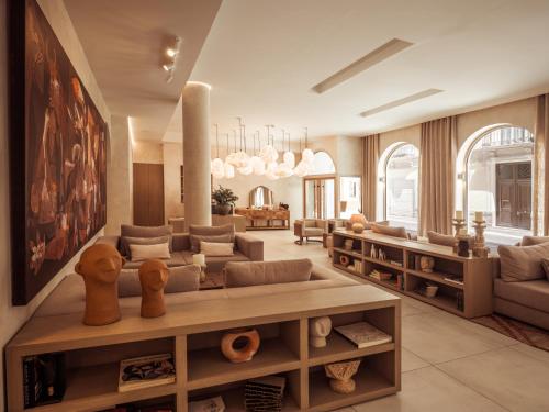 a living room with a couch and a table at Hotel Well and Come Málaga in Málaga
