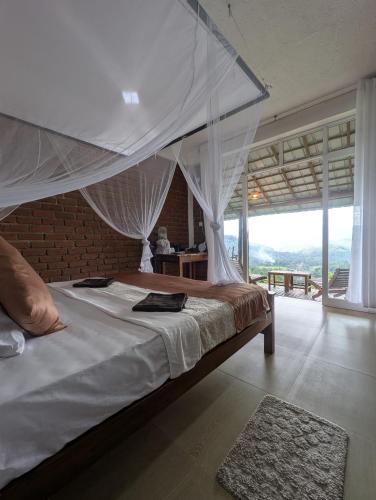 a bedroom with a large bed with a canopy at Brisk Ella Retreat in Ella