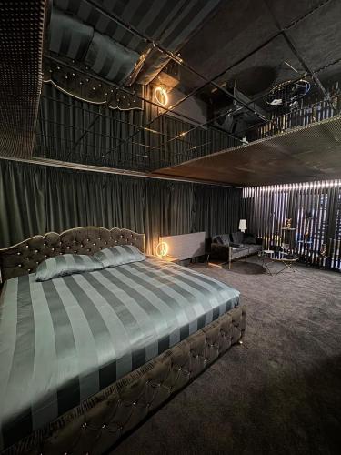 a bedroom with a bed and a desk in it at Moonlight jacuzzi in Stargard