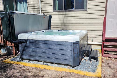 a hot tub sitting outside of a house at House in the Woods in Albrightsville